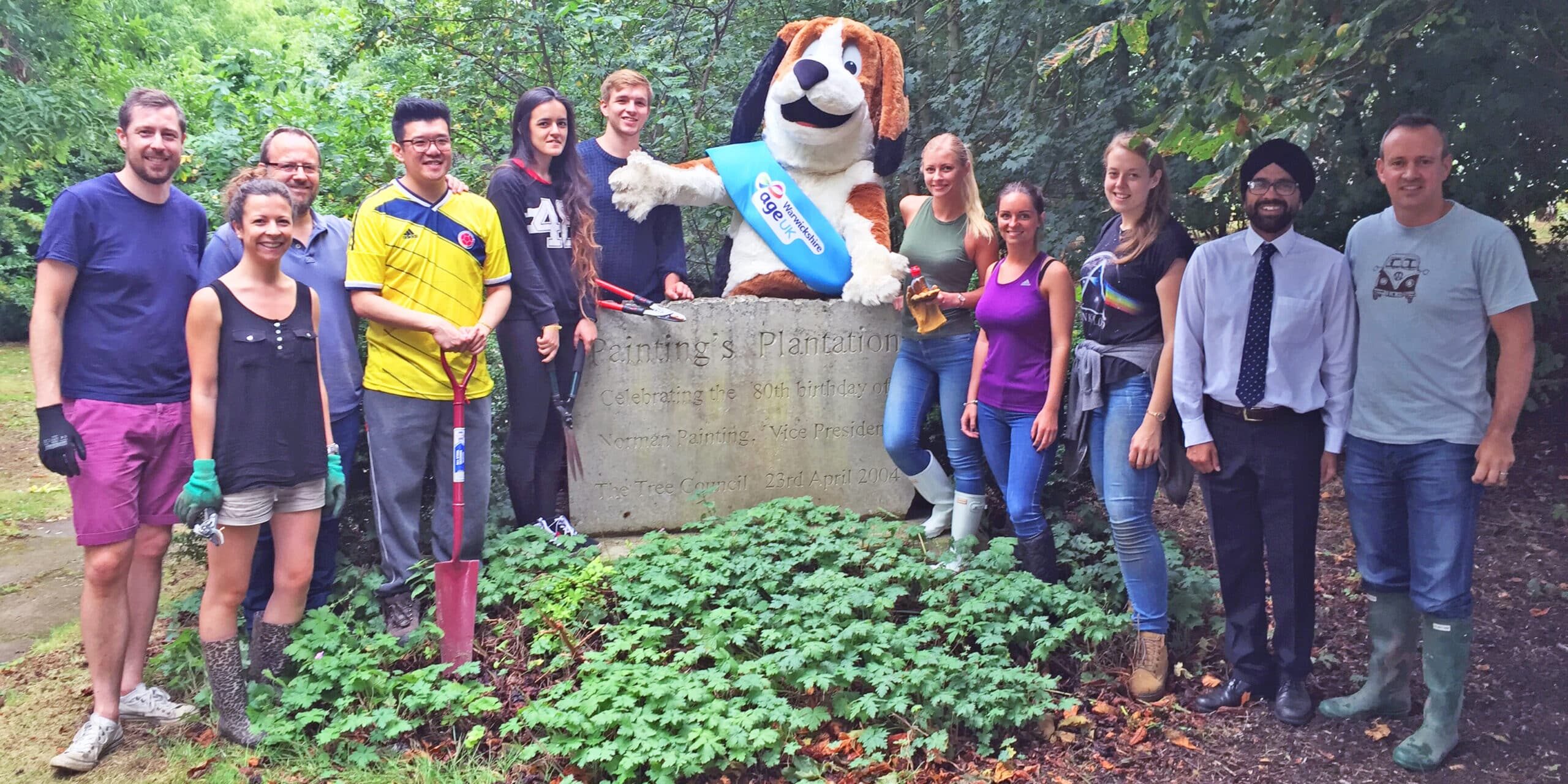 Fuel Recruitment team volunteering for Age UK posing for photograph with Harvey the Hound