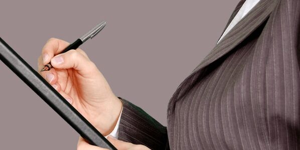 Business person with checklist and pen