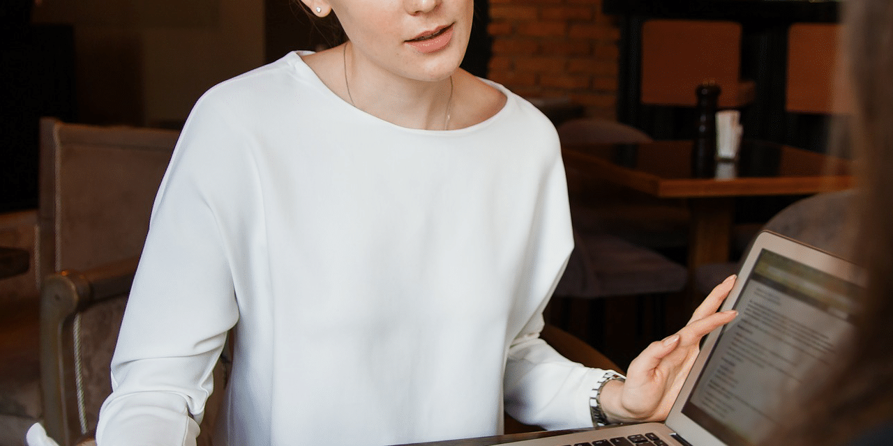 Interviewer taking notes during an interview, interviewee is just out of shot